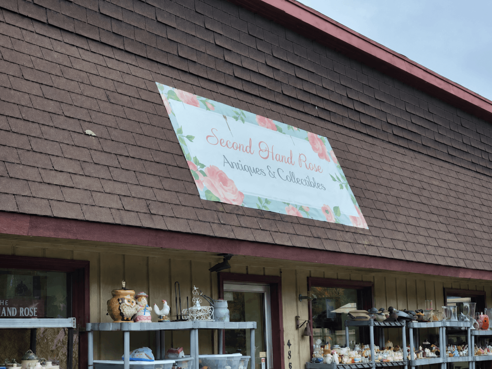 Second Hand Rose Antiques antique store on Highway 61 in Beaver Bay, Minnesota, between Silver Bay and Two Harbors, with the original rose sign on the roof and outdoor vintage displays
